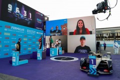 The trophy presenters on the big screen during the podium