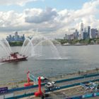 An FDNY Fire Tender sprays its hoses in the Hudson River after the race